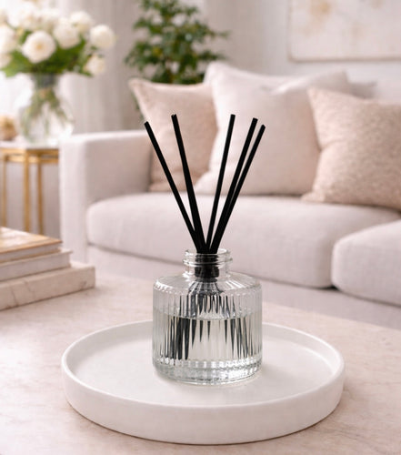 Daisy Blue Home Fragrance Rivelle Reed Diffuser Bottle with wooden reeds and decorative glass container for home fragrance.