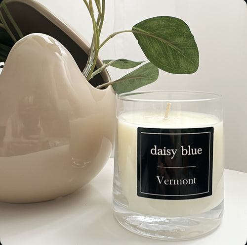 Daisy Blue Home Fragrance Lumière Candle Jar with elegant glass design and soft white wax, perfect for ambient lighting.